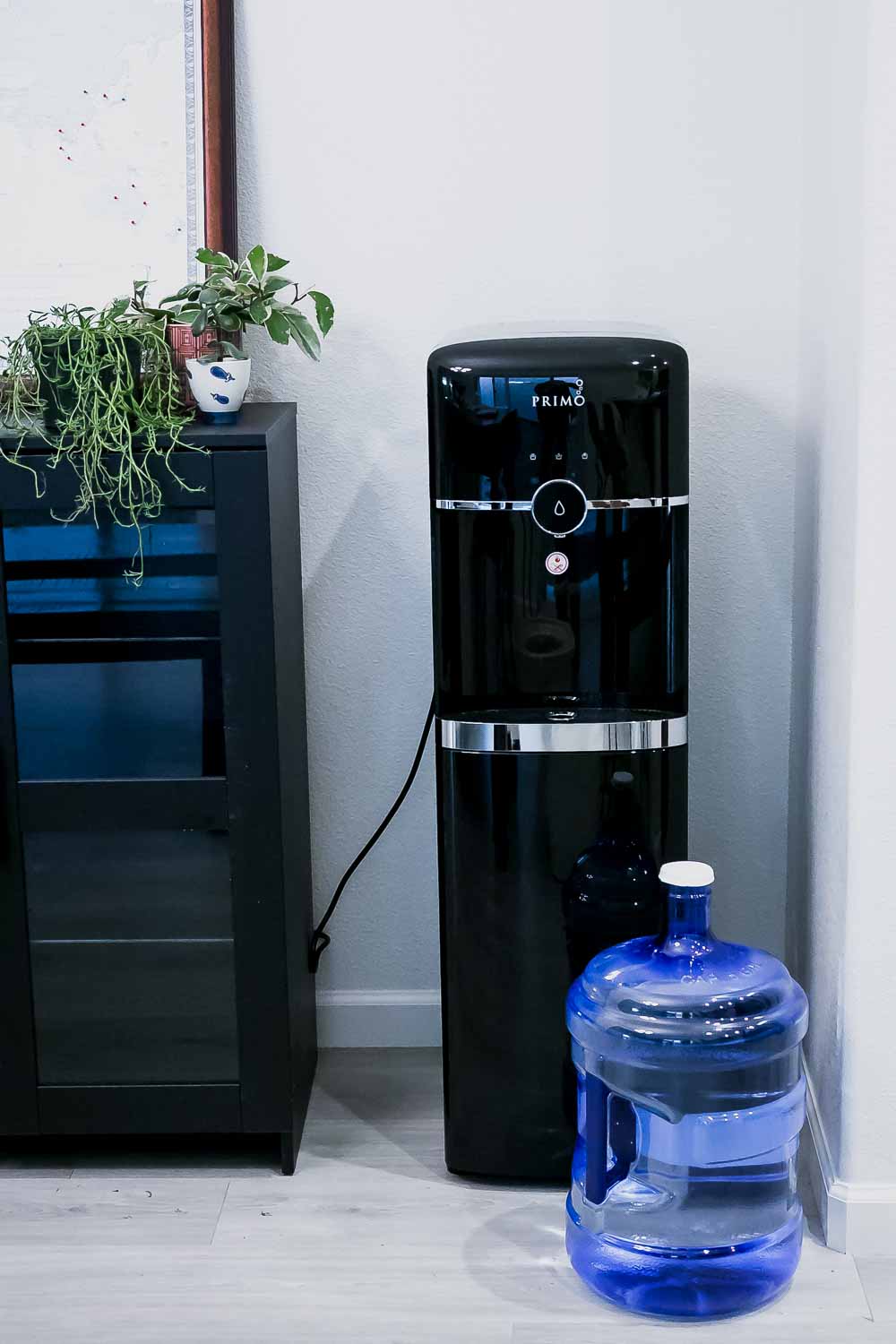 a primo water dispenser in a kitchen corner