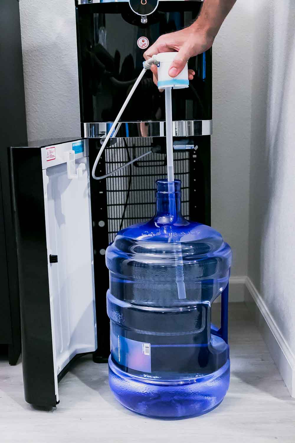 a 5-gallon water bottle hooked up to a primo water dispenser