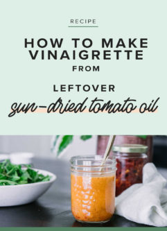 a mason jar with tomato dressing on a wooden table and a green graphic with the words "leftover sun-dried tomato oil vinaigrette"