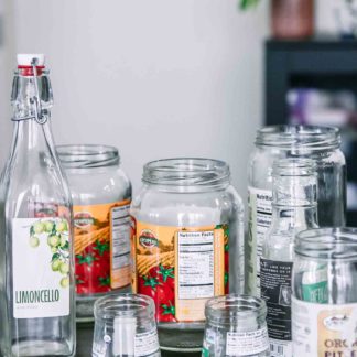 empty glass food jars with labels on a wooden table