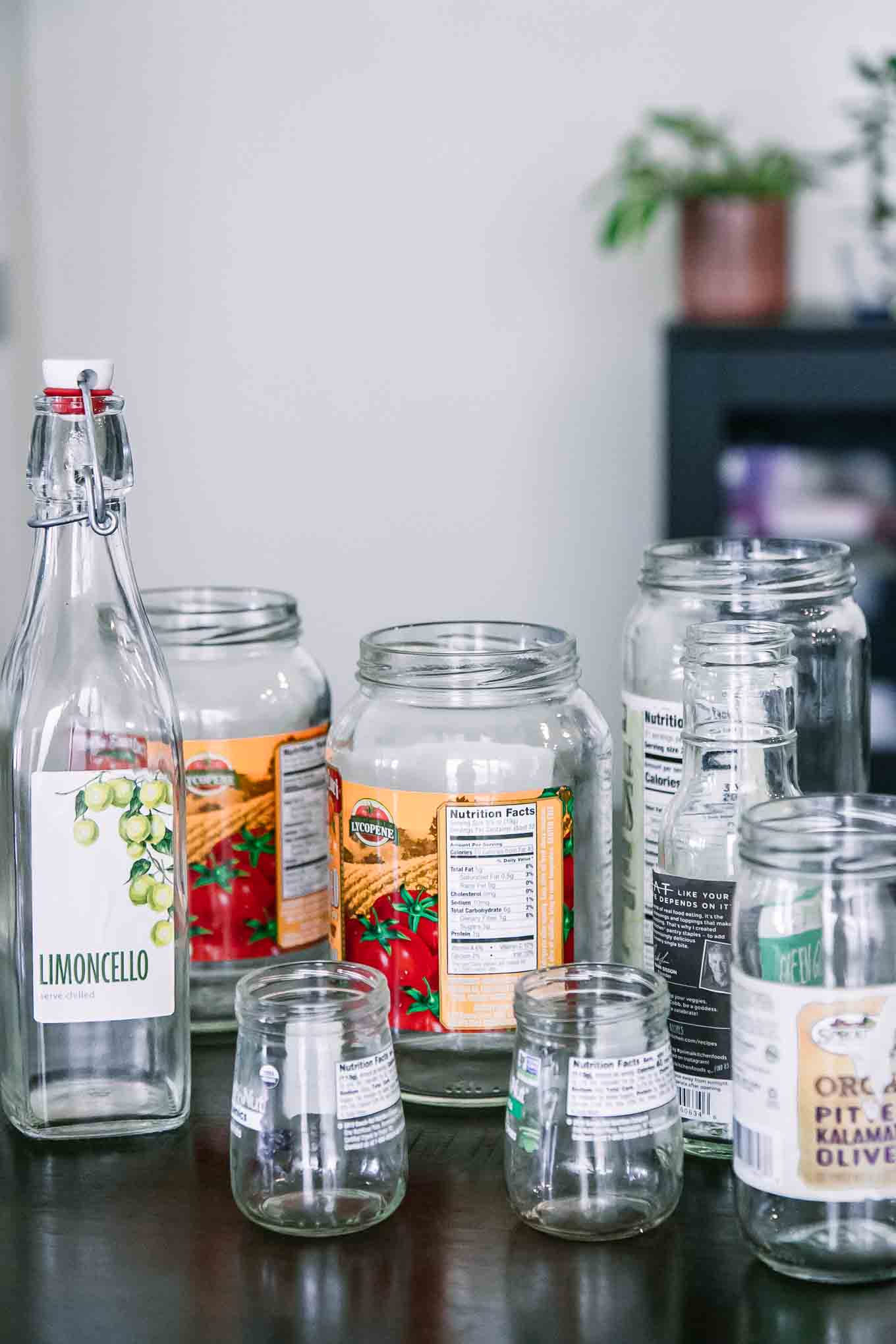 empty glass food jars with labels on a wooden table