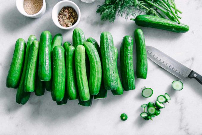 persian cucumbers with stems cut off on a white table