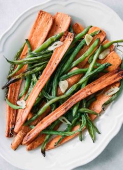 roasted green beans and carrots on a white plate