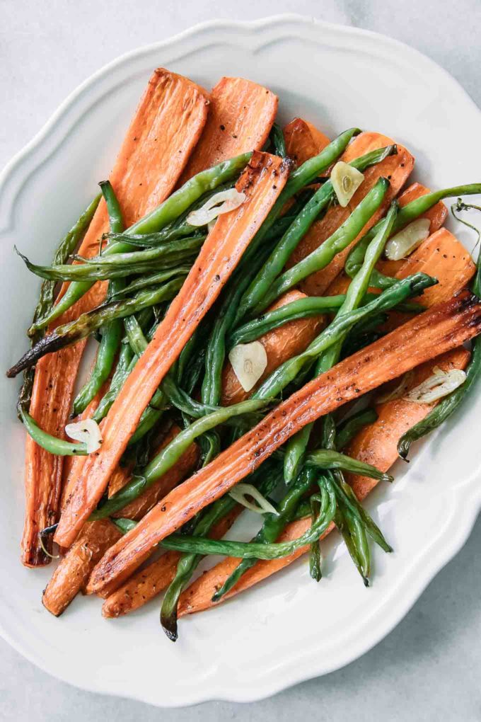 green beans and carrots on a white plate