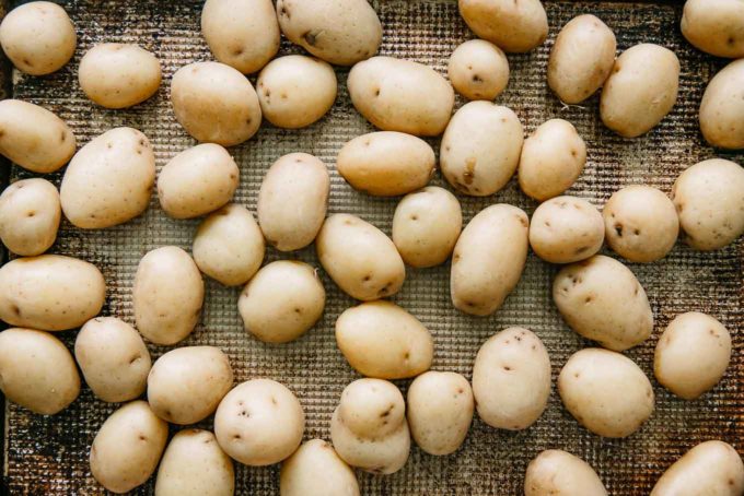 white creamer potatoes on a baking sheet