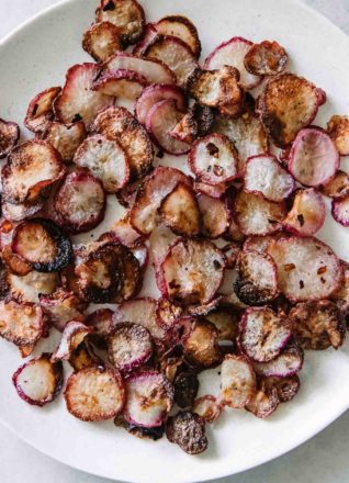 baked radish chips on a white plate