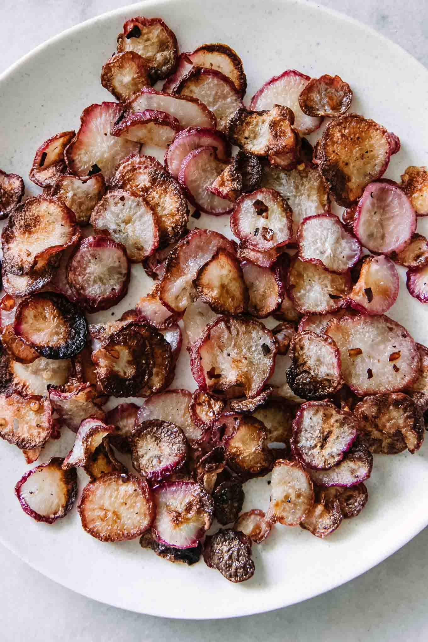 baked radish chips on a white plate