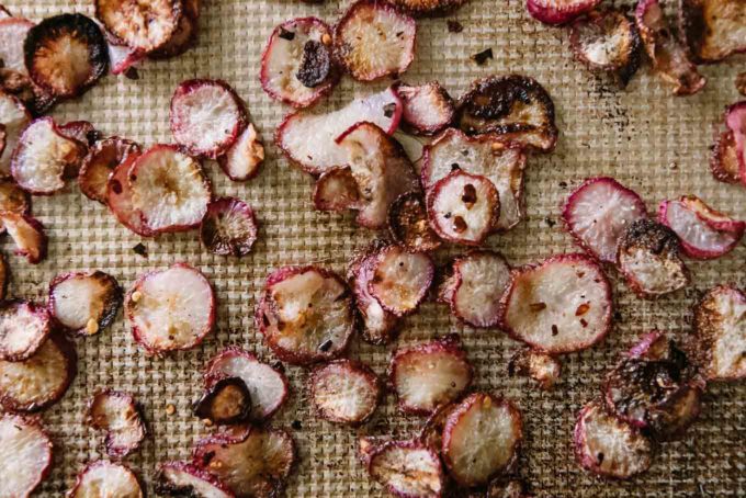 roasted radish chips on a baking sheet