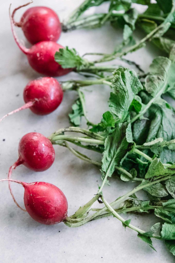 red radishes with green leaves