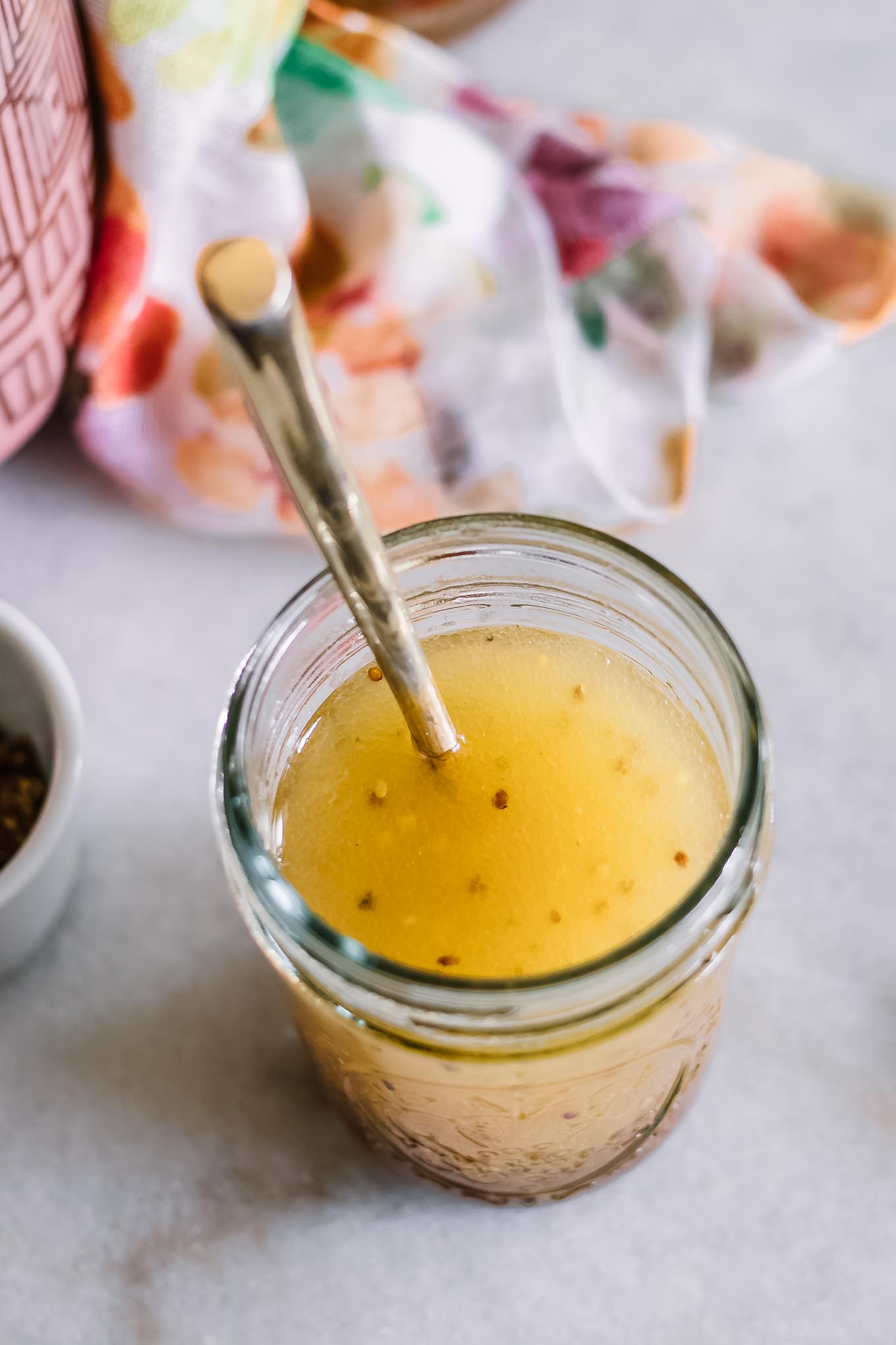 salad dressing in a mason jar on a white table