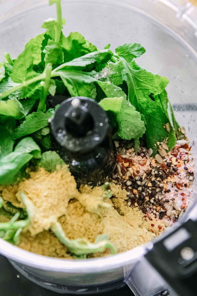 pesto ingredients inside a food processor