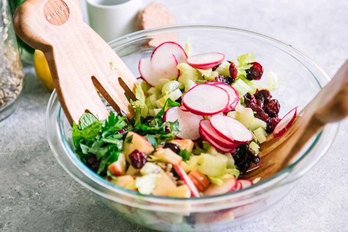 two large wooden spoons in a large salad bowl