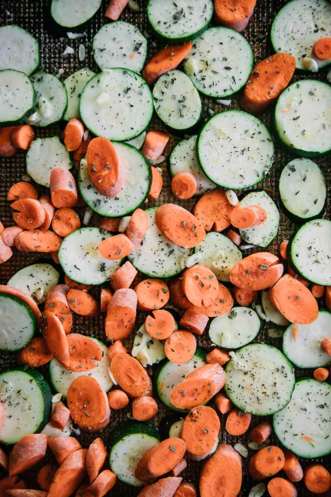 sliced carrots and zucchini on a baking sheet
