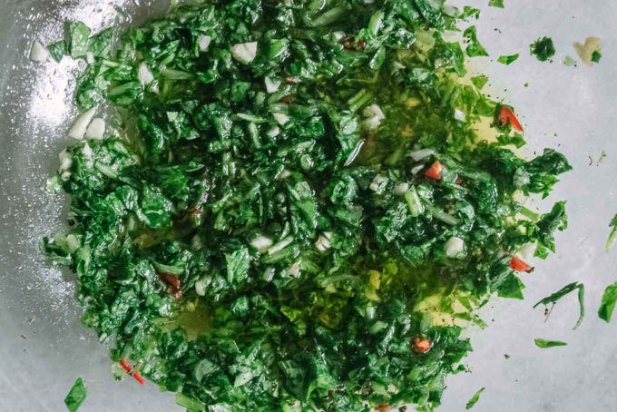 a closeup photo of chimichurri sauce