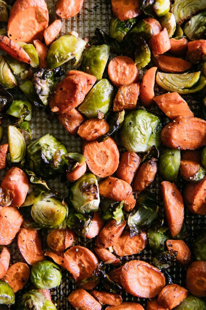 roasted brussels sprouts and carrots on a sheet pan