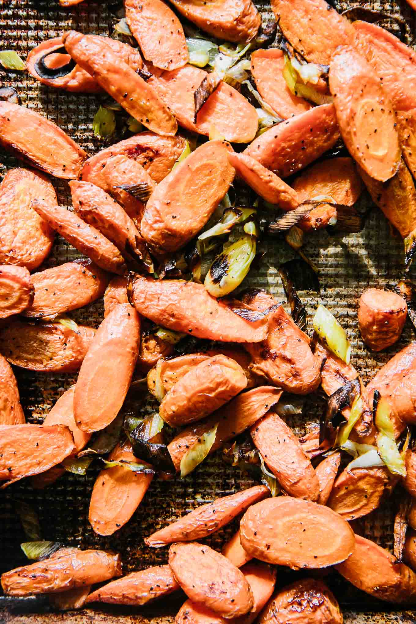 roasted carrots and leeks on a baking sheet
