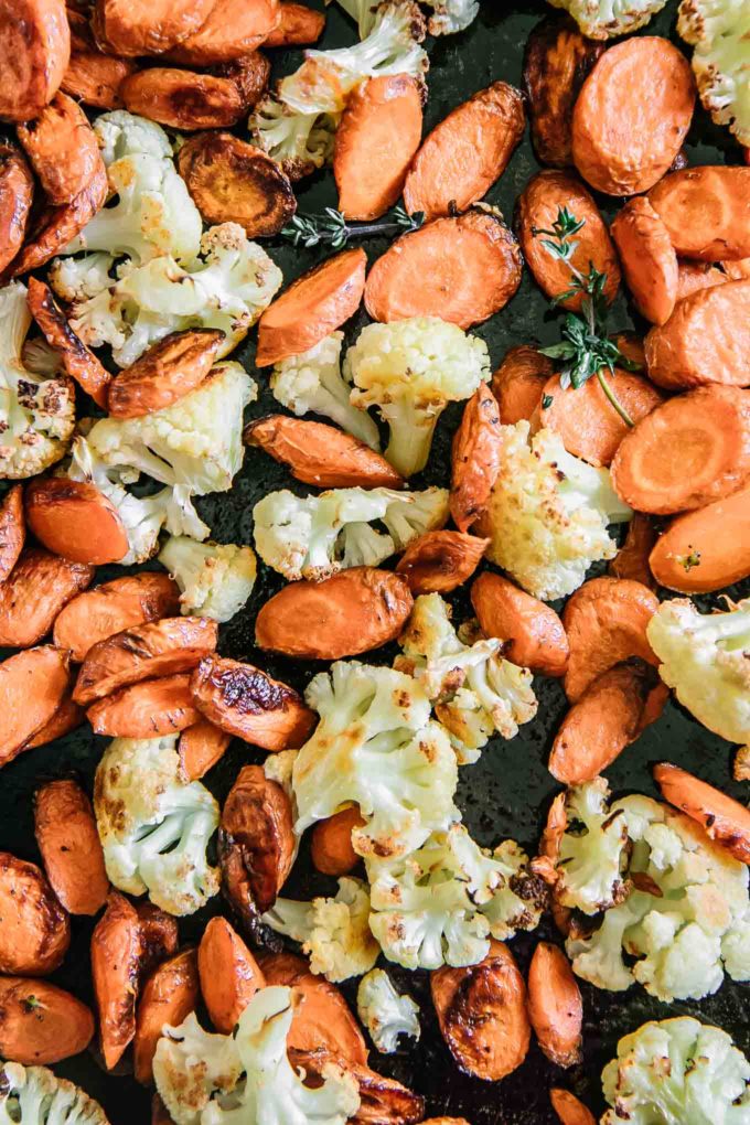 roasted carrots and cauliflower on a sheet pan after baking