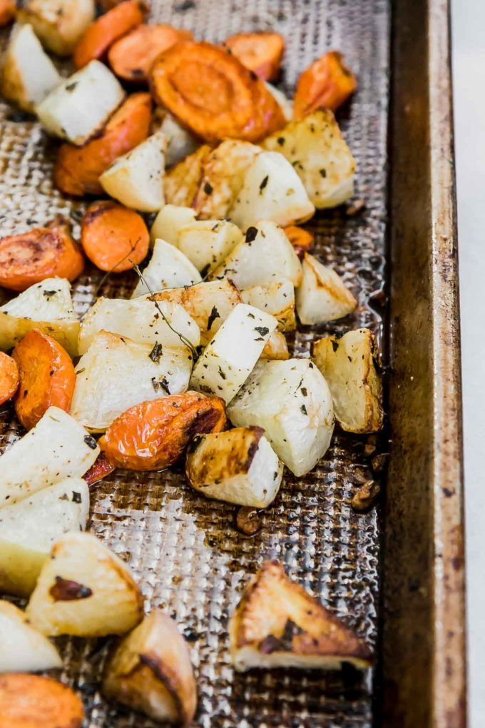 carrots and turnips on a sheet pan after roasting