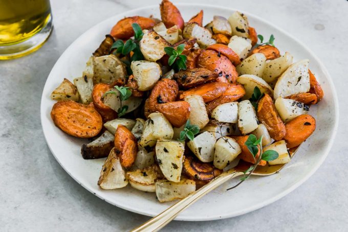 roasted carrots and turnips on a white plate on a white table