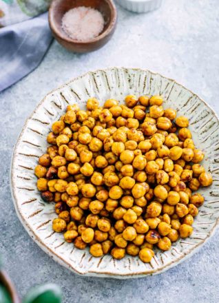 roasted chickpeas in a white bowl on a blue table