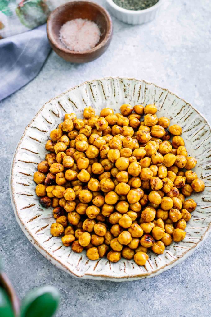 roasted chickpeas in a white bowl on a blue table