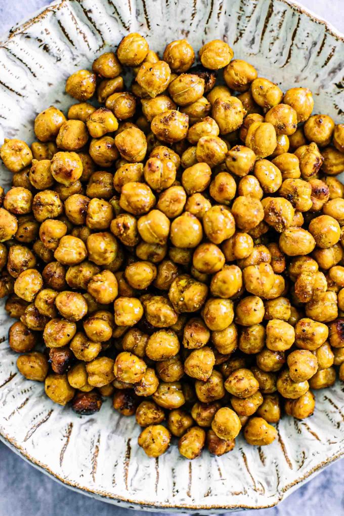 a close up photo of crispy baked chickpeas in on a white plate