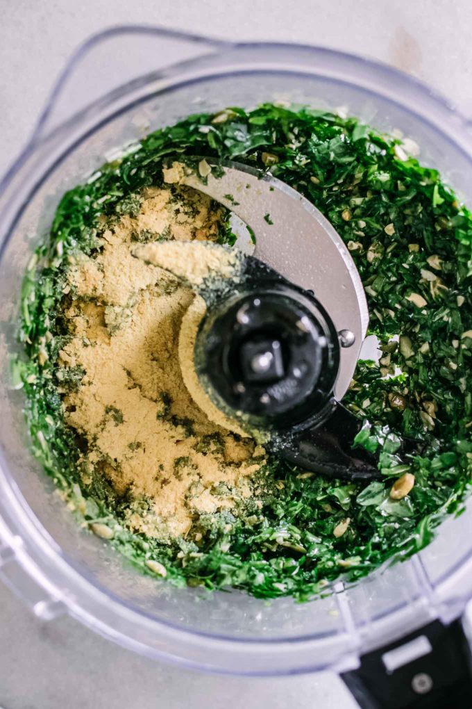 blended pesto with nutritional yeast inside a food processor