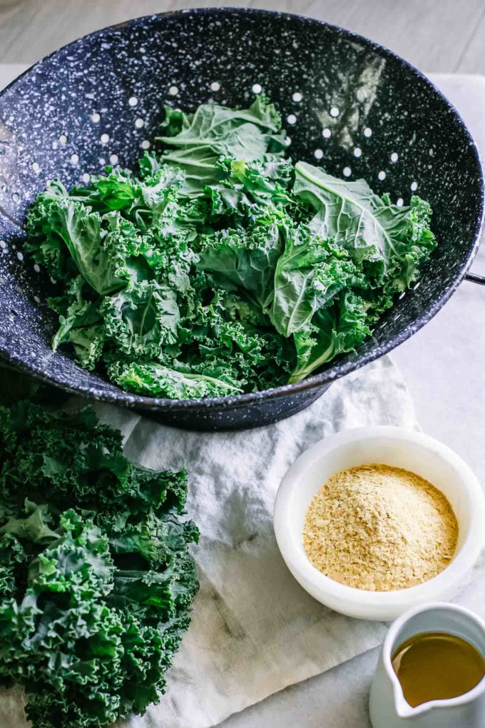 kale in a colander on a white counter