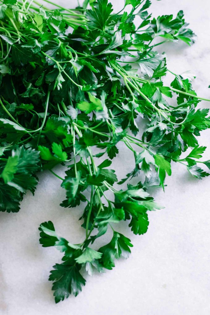 cleaned parsley on a white countertop