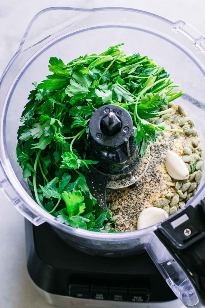 parsley, nutritional yeast, garlic, and spice inside a food processor