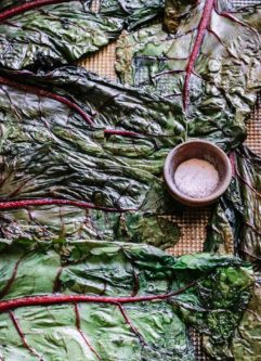 baked chard leaves on a sheet pan with salt