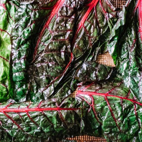 chard leaves on a table with sprinkled salt