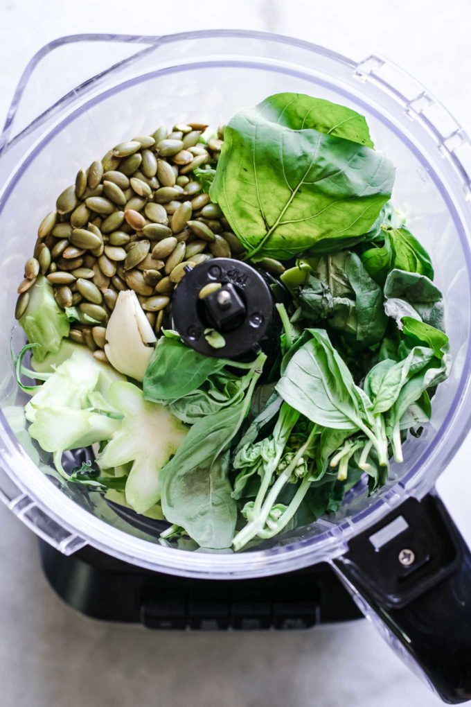 broccoli stems, basil, nuts, and garlic in a food processor