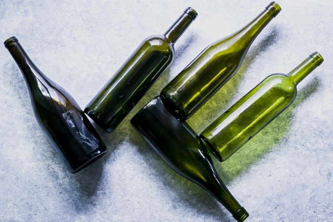 empty wine bottles on a blue table