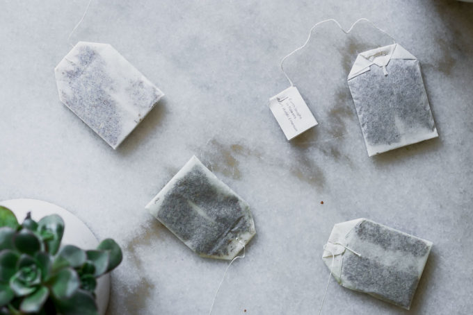 tea bags with strings on a marble countertop