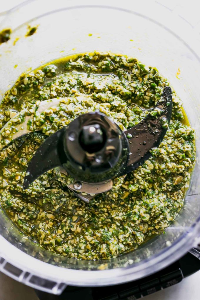 blended pepita pesto sauce inside a food processor