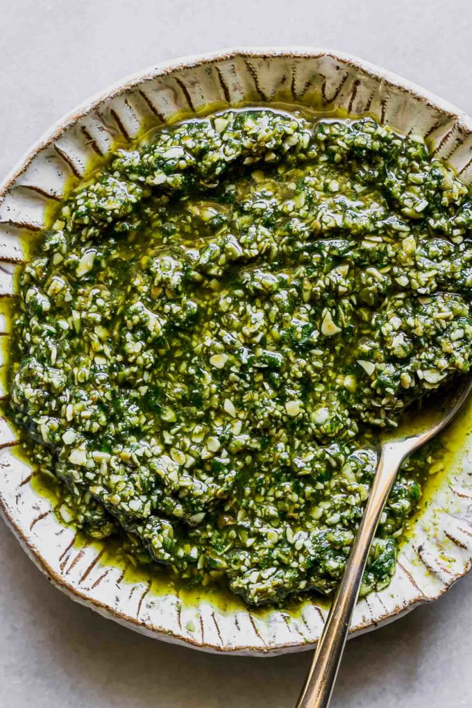 pumpkin pesto sauce on a gold plate on a white table