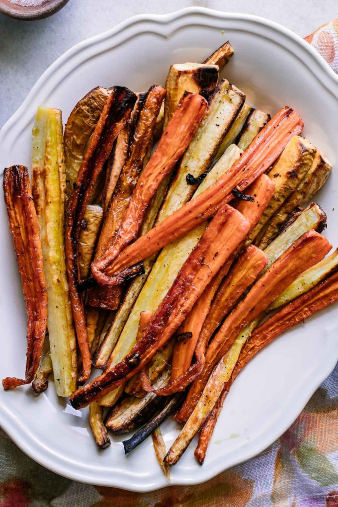 roasted carrots and parnsips on a white serving plate