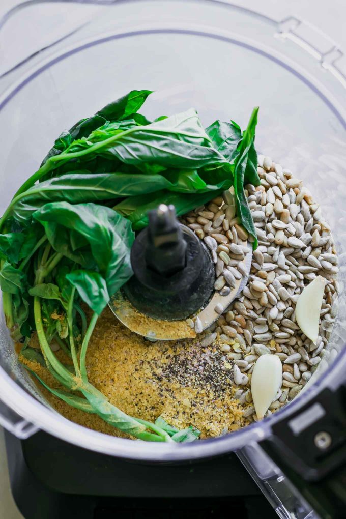 basil, sunflower seeds, cheese, and garlic in a food processor