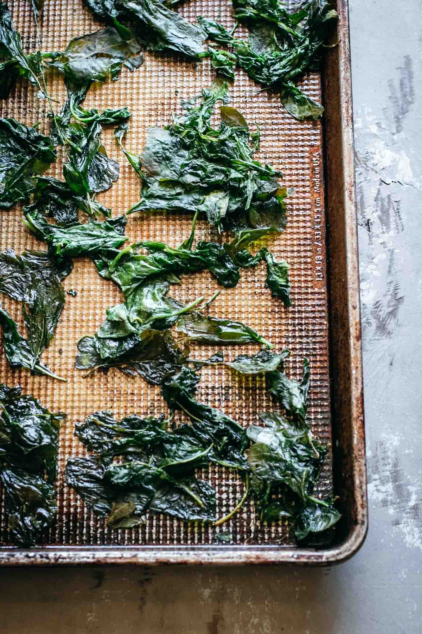 close up view of radish greens on a baking sheet