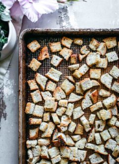 homemade rye bread croutons on a baking pan