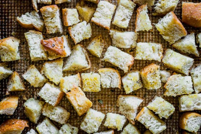 seasoned sourdough croutons on a baking sheet