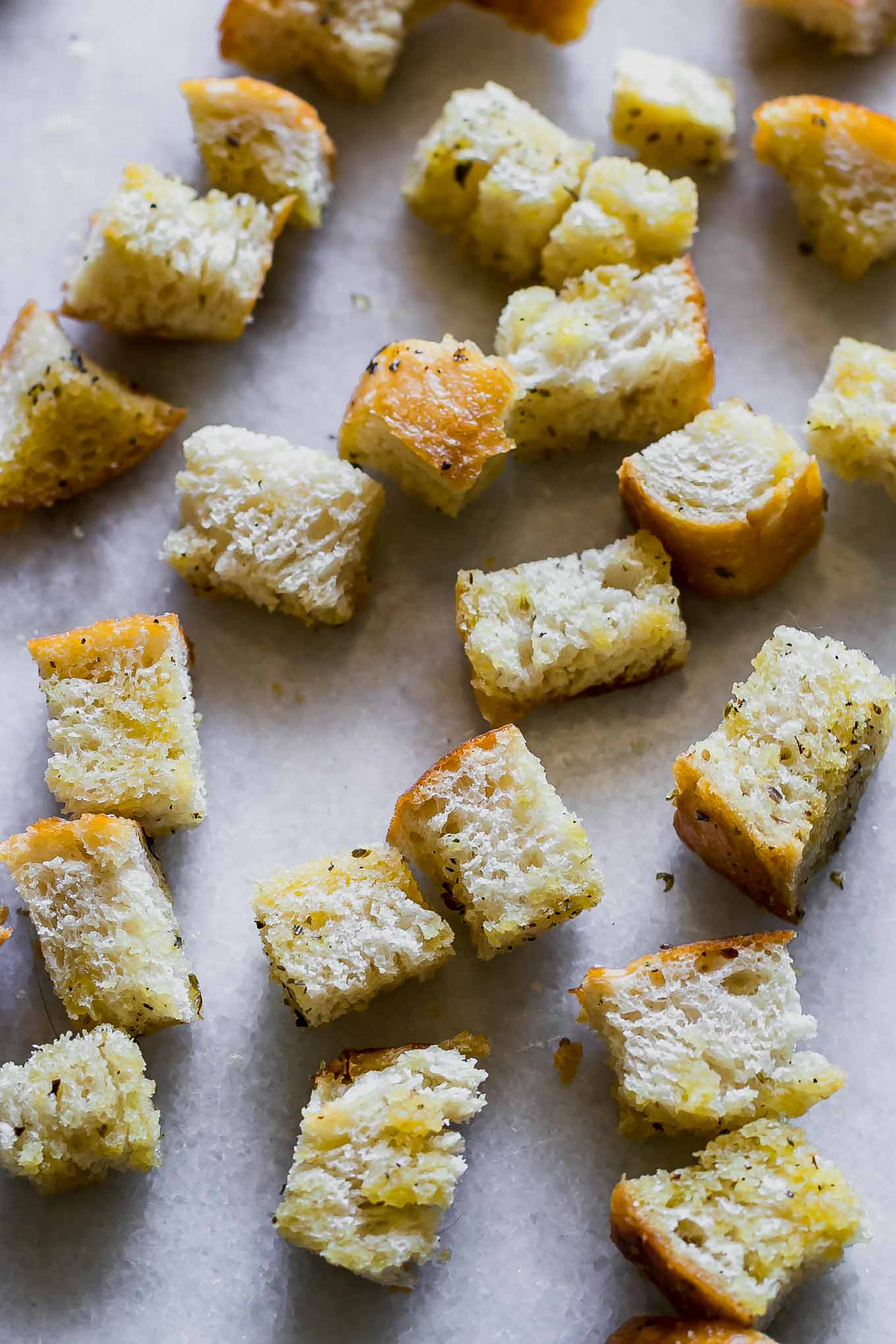 crispy sourdough croutons on a white marble countertop