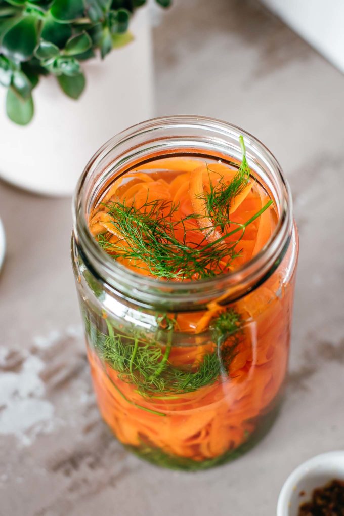 jar with carrot ribbons, dill and spices