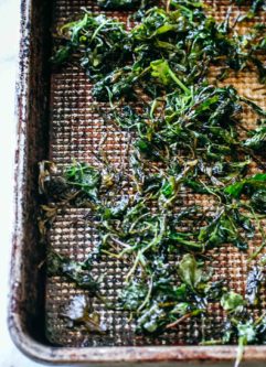 baked arugula leaves on a sheet pan