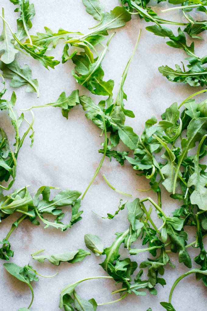 arugula leaves on a marble countertop