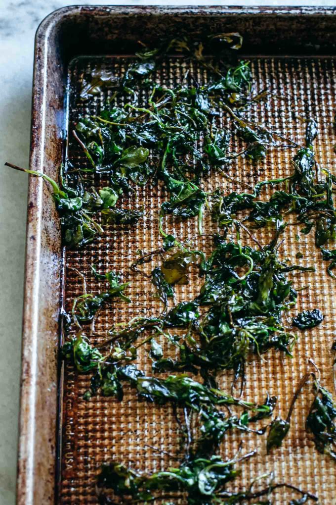 baked arugula on a baking sheet