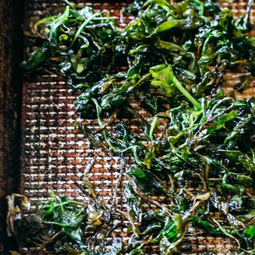 crispy roasted arugula on a baking sheet