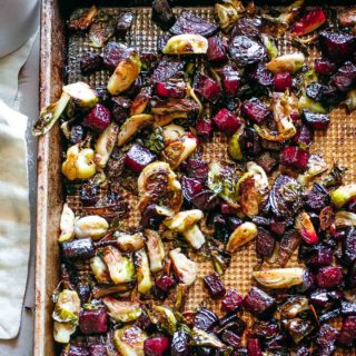 roasted beets and brussels sprouts on a baking sheet