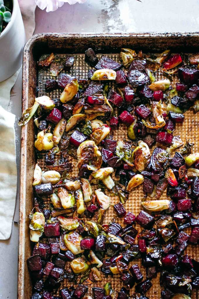 roasted beets and brussels sprouts on a baking sheet